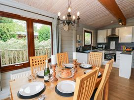 A dining room with a table and chairs at Mountain View in Rhayader
