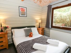 A bedroom with a bed and nightstand at Mountain View in Rhayader