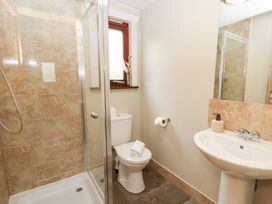 A bathroom with a shower, toilet, and sink at Mountain View in Rhayader