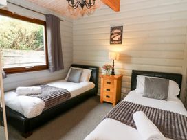 A bedroom with two single beds and a nightstand at Mountain View in Rhayader