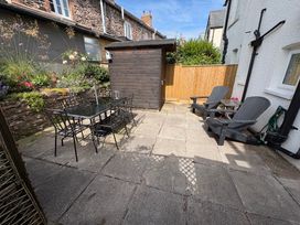 A garden with a table and chairs at 3 Lowerbourne Terrace Porlock