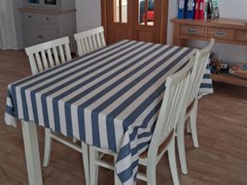 A table with stripes and chairs at Buttercups at Midway in Kington