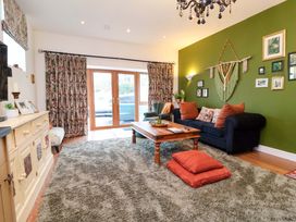 A living room with a coffee table and a sofa at The Coach House, The Grove in Combe Martin
