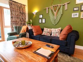 A living room with a sofa and coffee table at The Coach House, The Grove in Combe Martin