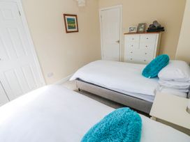 A bedroom with two beds and a dresser at Mountain Farm in Broad Haven