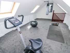 A gym with exercise equipment and a punching bag at Mountain Farm in Broad Haven