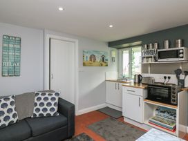 A kitchen with cabinets and appliances at Hidden Treasure in Brixham