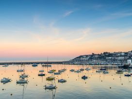 A view of sailboats in a marina during sunset at Hidden Treasure in Brixham