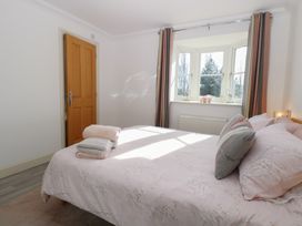 A bedroom with a bed and window at 5 Styleman Road Hunstanton