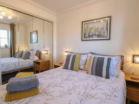 A bedroom with a bed and bedside table at 5 Styleman Road, Hunstanton