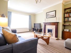 A living room with a sofa and television at Castle Cove in Abergele