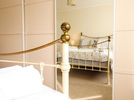 A bedroom with a bed and lamp at Castle Cove in Abergele
