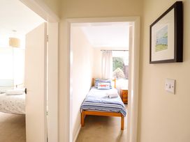 A bedroom with a bed and nightstand at Castle Cove in Abergele