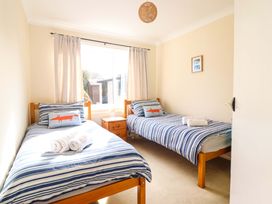 A bedroom with two beds and a window at Castle Cove in Abergele