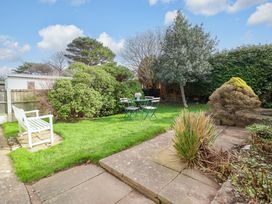 A garden with a table and chairs at Castle Cove in Abergele