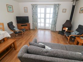 A living room with a sofa and armchairs at Pilchard Cottage in Sennen Cove