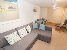 A snug with a foosball table and a sofa at Pilchard Cottage Sennen Cove
