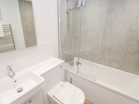 A bathroom with a sink, toilet, and bathtub at Pilchard Cottage Sennen Cove