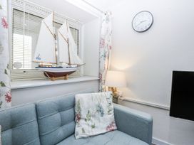 A living room with a model ship on a windowsill at 3 Tyn Giat Penysarn near Amlwch