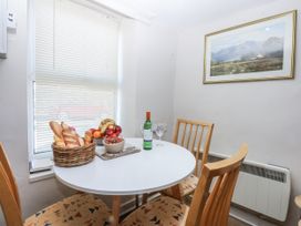 A dining room with a table and chairs at 3 Tyn Giat in Penysarn near Amlwch