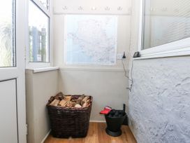 An entrance with a map and a basket of firewood at 3 Tyn Giat in Penysarn near Amlwch