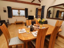 A dining room with a table set for breakfast at Stable D'or in Embleton