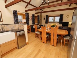 A kitchen with a dining area and appliances at Stable D'or Embleton