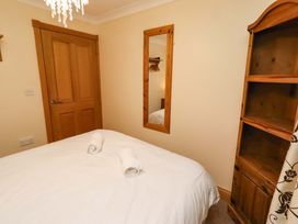 A bedroom with a bed and towels at Stable D'or in Embleton