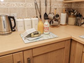 A kitchen countertop with a kettle, containers, and dairy items at The Retreat in Embleton