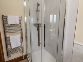 A shower and towel rail in a bathroom at The Retreat in Embleton