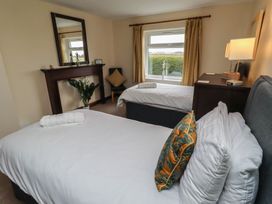 A bedroom with two beds and a window at The Retreat in Embleton