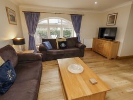 A living room with a sofa and television at Low Croft in Embleton