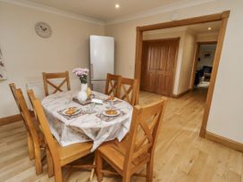 A dining room with a table and chairs at Low Croft in Embleton