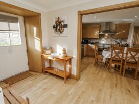 A kitchen area with wooden table and chairs at Low Croft in Embleton
