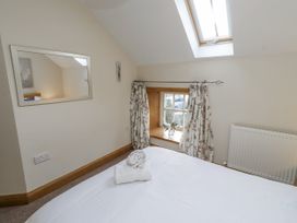 A bedroom with a bed and window at Low Croft in Embleton