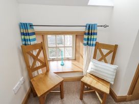 A sitting area with two chairs and a window at Low Croft in Embleton