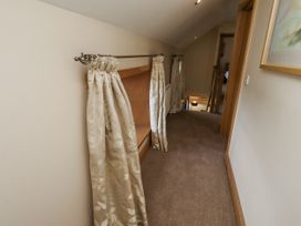 A hallway with curtains and a shelf at Low Croft in Embleton