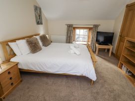 A bedroom with a bed, television, and dresser at Low Croft in Embleton