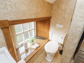 A bathroom with a toilet and window at Low Croft in Embleton