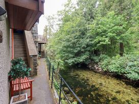 An outdoor pathway with stairs and a stream located at Drystones in Grasmere