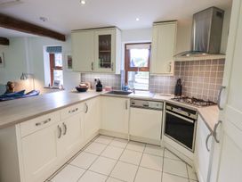 A kitchen with cabinets and appliances at Drystones in Grasmere