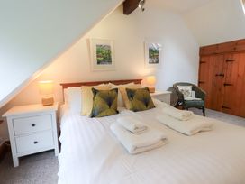 A bedroom with a bed and bedside tables at Drystones in Grasmere