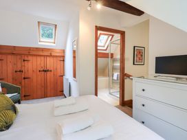 A bedroom with a bed and dresser at Drystones in Grasmere