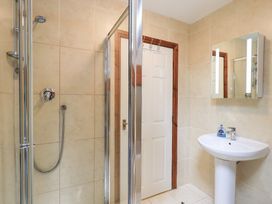 A bathroom with a shower and sink at Drystones in Grasmere