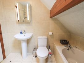 A bathroom with a sink, toilet, and bath tub at Drystones in Grasmere