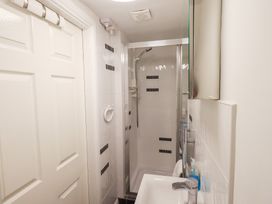 A bathroom with a shower and sink at Drystones in Grasmere