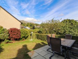 A garden with a table and chairs at Sunbeam Cottage in Coniston