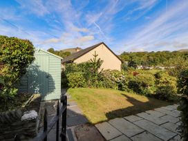 A garden with a shed and plants at Sunbeam Cottage in Coniston