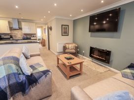 A living room with a sofa and coffee table at Lakeland Loft in Windermere