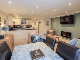 A living room with a kitchen area at Lakeland Loft Windermere